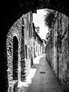 Picturesque medieval narrow street of San Gimignano old town, Tuscany, Italy Royalty Free Stock Photo