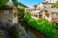 Picturesque medieval stone buildings house cafes and restaurants with patios near the river Neretva in Mostar, Bosnia-Herzegovina