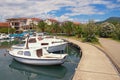 Picturesque Mediterranean landscape. Embankment of seaside town, with view of fishing boats in harbor. Montenegro, Tivat city Royalty Free Stock Photo