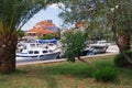 Picturesque Mediterranean landscape. Red roofs of seaside town and fishing boats in harbor from green park. Montenegro, Tivat city Royalty Free Stock Photo