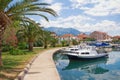 Picturesque Mediterranean town embankment with view of fishing boats in harbor. Montenegro, Tivat city Royalty Free Stock Photo