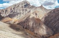 Picturesque mountain landscape with ancient Silk Way remains on the endless Leh - Manali road. Blue sky with white clouds and Royalty Free Stock Photo