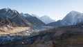 Picturesque mountain landscape featuring snow capped peaks in a rocky terrain with a small village Royalty Free Stock Photo