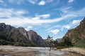 Picturesque mountain landscape on sunny summer day. River and rocky mountains against a blue sky. Pine tree stands in the water on Royalty Free Stock Photo