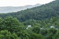 Picturesque mountain serpentine road with green forest peaks of the Caucasus Mountains. Spring landscape at the pass