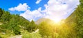 Picturesque mountains, meadow, bright sunrise and walking path. Wide photo Royalty Free Stock Photo