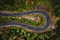 Picturesque mountains and serpentine roads, forest and road in the fog, steep turns of roads, road in the mountains.