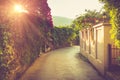 Picturesque narrow street decorated with plenty of flowers at sunshine. Budva. Montenegro.