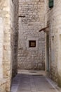 Picturesque narrow street with stone houses. Trogir, Dalmatia, Croatia, Europe Royalty Free Stock Photo