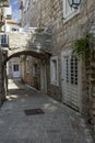 A picturesque narrow street with stone houses typical for Mediterranean countries, Budva, Montenegro