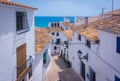 Picturesque narrow street in white village of Altea, Alicante, Spain