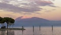 Picturesque natural landscape with stunning sunset over serene lake framed by majestic snow-capped mountain peak in background. Royalty Free Stock Photo