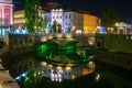 Picturesque night view of illuminated Triple Bridge and Mayer Palace in Ljubljana, Slovenia