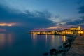 Picturesque nightscape of coastline of Adriatic sea with illuminated houses and lighthouse at twilight, Piran, Slovenia