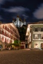 Picturesque nightscape of illuminated buildings and castle of Thun, Switzerland under starry sky