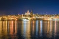 nighttime view of Valletta, the capital of Malta, with a reflection of the city in the water