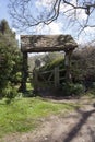 The picturesque old lychgate frames the tiny old Saxon church in spring sunshine at Duntisbourne Rouse