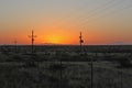 Picturesque outdoor scene of a stunning desert sunrise, with power lines in the background