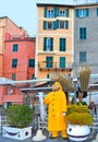 31.03.2019. Picturesque panorama with advertising yellow statue of fisherman in front of restaurant in the harbor with colorful ho