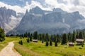 Picturesque path on a high alpine meadow surrounded by foggy peaks. Italian Dolomites.