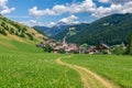 Picturesque path leading to a small beautiful alpine town Longiaru Campill Royalty Free Stock Photo