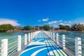 a picturesque pier at the rafai beach pier going under water with steps. Clear turquoise water and blue sky. Travel and recreation