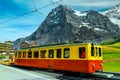 Picturesque place with mountains and old tourist train, Grindelwald, Switzerland