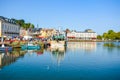 The picturesque port harbour at Honfleur France, on the coast of Normandy, with a fishing boat, smaller boats, and seagulls