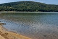 Picturesque Rabisha lake with authentic shore, bivouac and mountain over Magura cave