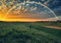 picturesque rainbow over the river. tourist enjoys colorful sunrise Royalty Free Stock Photo