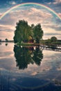 picturesque rainbow over a wooden hut on a small island Royalty Free Stock Photo