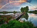 Picturesque rainbow over a wooden hut on a small island Royalty Free Stock Photo