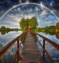 Picturesque rainbow over a wooden hut on a small island Royalty Free Stock Photo