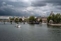 River Seine With Tourist Boat and Bridge Pont Neuf In Front Of Cathedral Notre Dame On Ile De La Cite In Paris, France Royalty Free Stock Photo