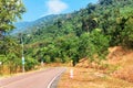 Picturesque road in mountains of National park Bokor leading to Abandoned hotel Bokor Palace in Ghost town Hill station near Kampo Royalty Free Stock Photo