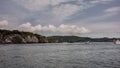 The picturesque rocky coast of Kamchatka against the background of blue sky and clouds Royalty Free Stock Photo