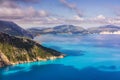 Picturesque rocky coastline on Kefalonia island. Amazing watercolor landscape in sunset light with cloudscape Royalty Free Stock Photo