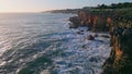 Picturesque rocky sea coast at evening sunlight drone view. Stormy dark ocean Royalty Free Stock Photo