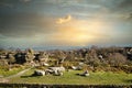 Picturesque rural landscape at sunset with rocky formations and green fields under a cloudy sky at Brimham Rocks, in North Royalty Free Stock Photo