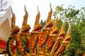 Picturesque scary heads of dragons stand at the entrance to old Thai temple. Ancient dragons guards in Buddhist religion, Thailand