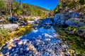 A Picturesque Scene with Fall Foliage on a Babbling Brook and Large Boulders at Lost Maples