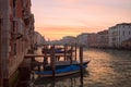 Picturesque scene of gondolas on canal in Venice, Italy, surrounded by urban buildings at sunset Royalty Free Stock Photo