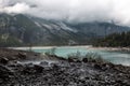 a steaming hot springs is located near a mountain and water