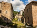 Picturesque scene of a small waterfall surrounded by stone buildings. Rasiglia, Italy. Royalty Free Stock Photo
