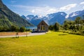 Picturesque scene of Urke village and Hjorundfjorden fjord, Norway. Drammatic sky and gloomy mountains. Landscape