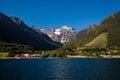 Picturesque scene of Urke village and Hjorundfjorden fjord, Norway. Drammatic sky and gloomy mountains. Landscape