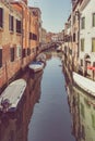 Picturesque Scene from Venice with many boats parked on the narrow water canals