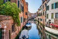 Picturesque Scene from Venice with many boats parked on the narrow water canals