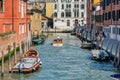 Picturesque Scene from Venice with stone bridges over the water canals and the boat traffic