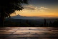 A picturesque scene wooden table with a sunset, sky, tree, mountains Royalty Free Stock Photo